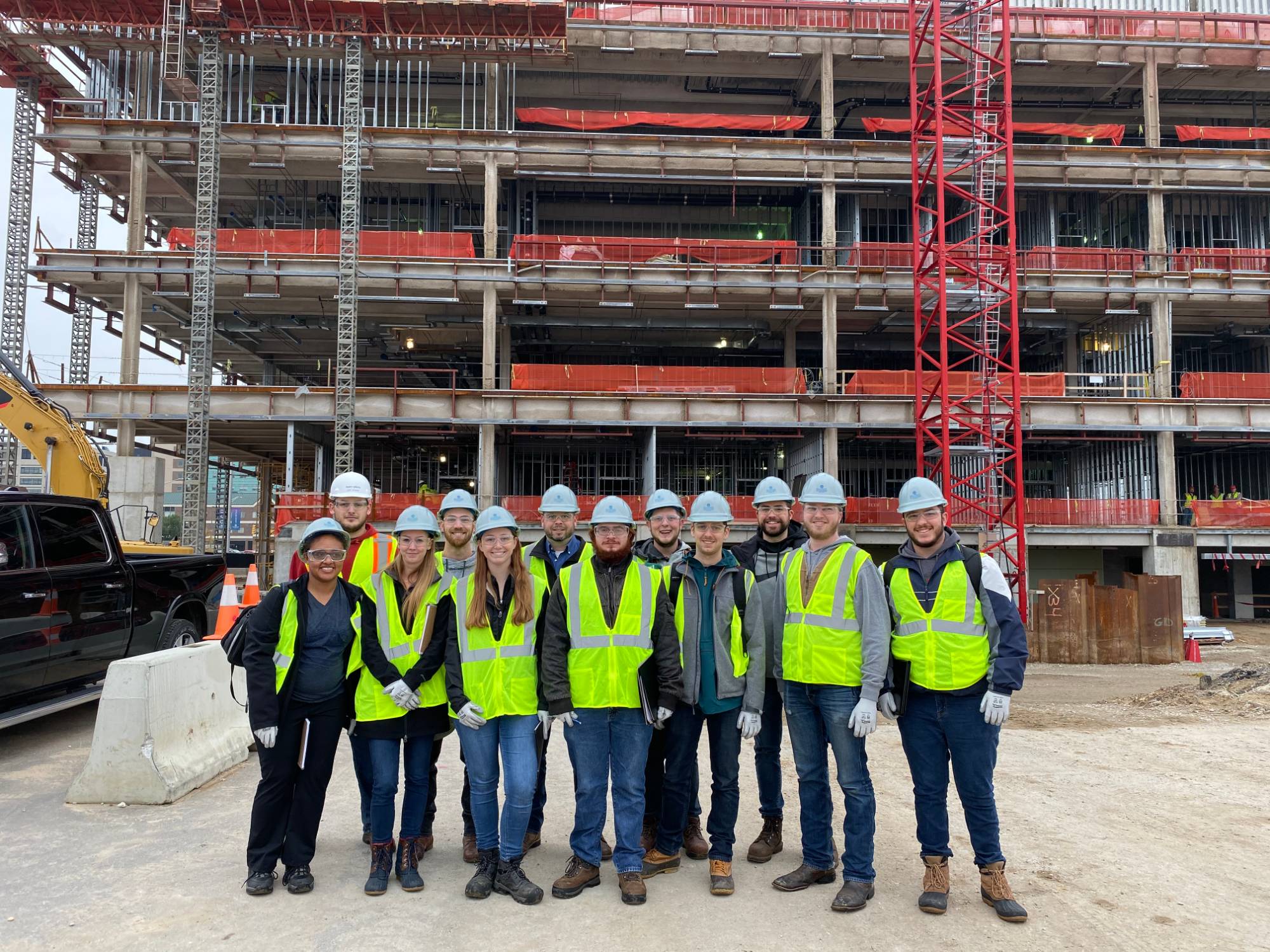 OSH students in front of a building under construction